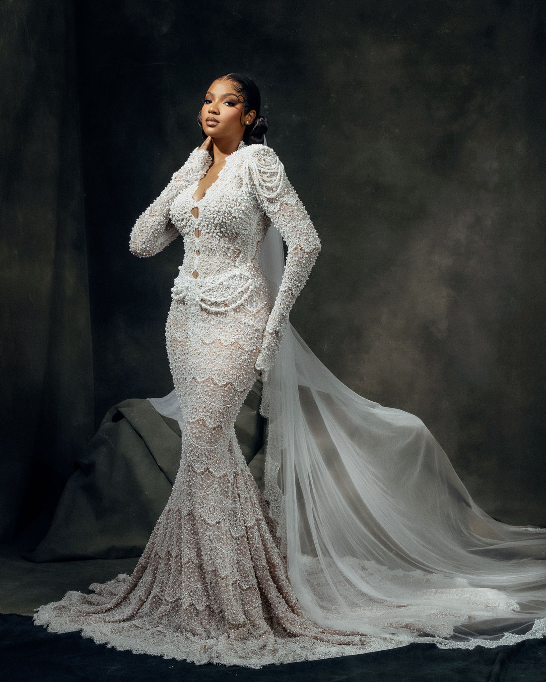 Nyame custom long-sleeve beaded mermaid wedding dress in white by House of Kenneth Tetteh